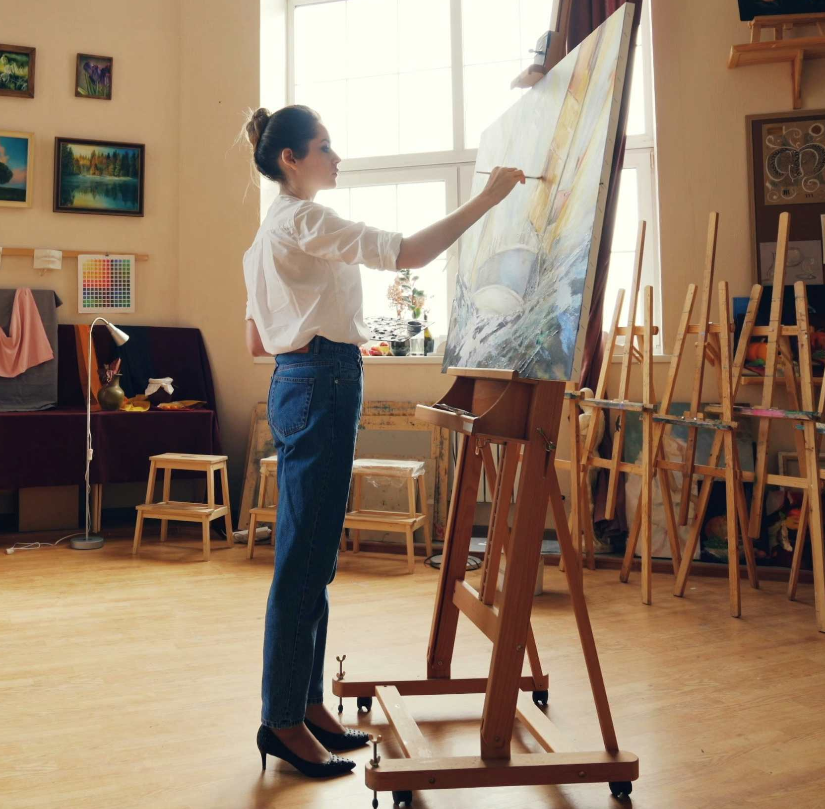 artist working on a painting in a studio